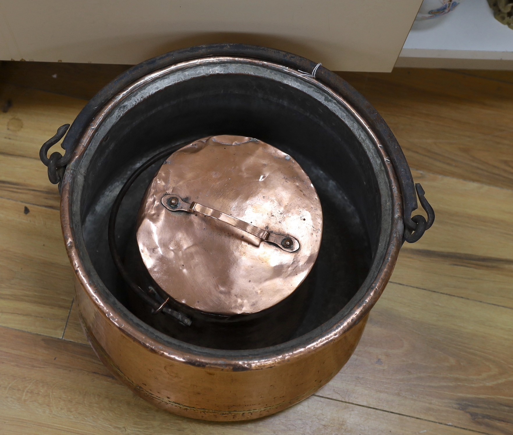 An 18th century French copper cauldron and two others